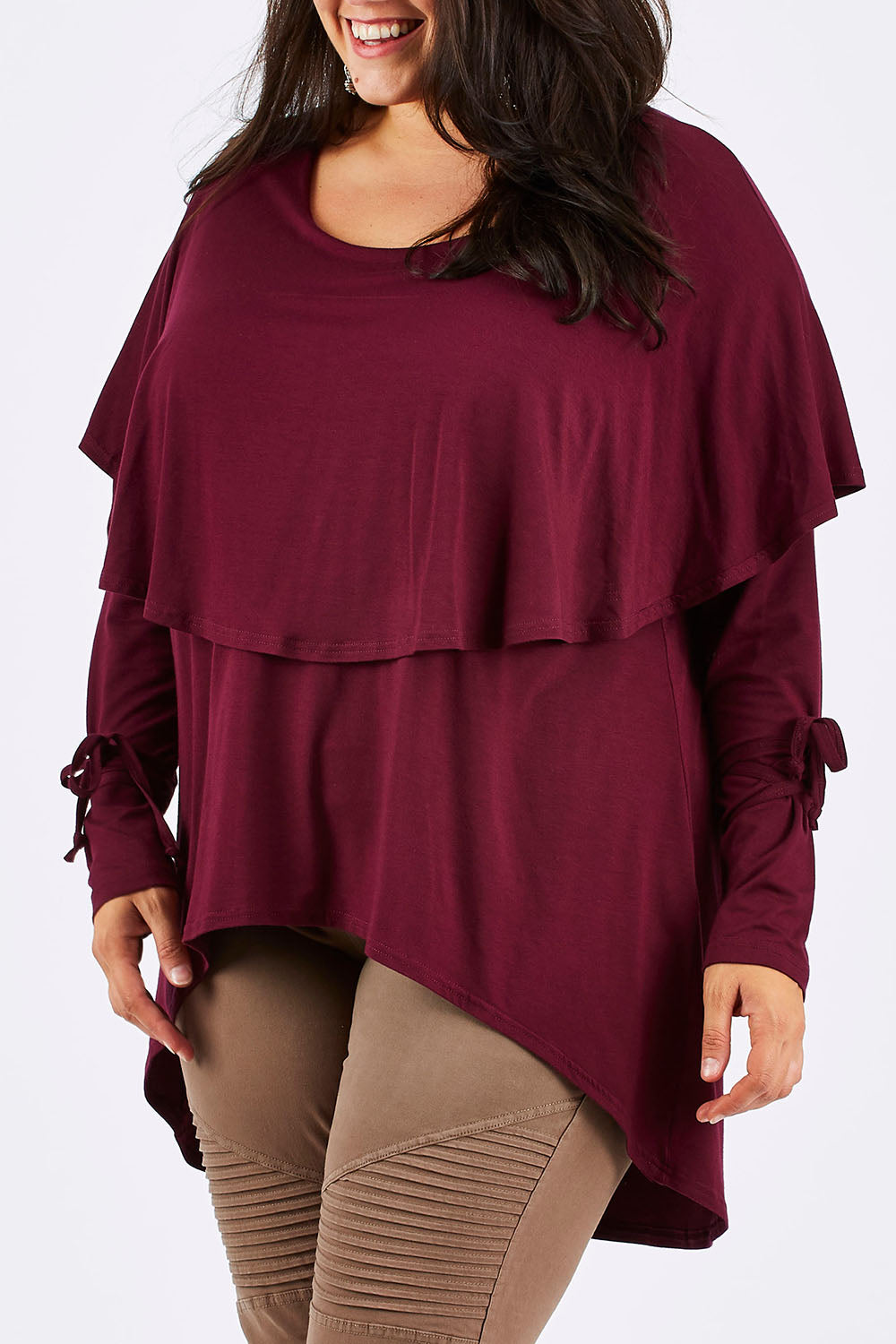 Model Mae wearing size 18 of the Cape Horn Tunic in colour Scarlet (Purple), from the front, cropped image