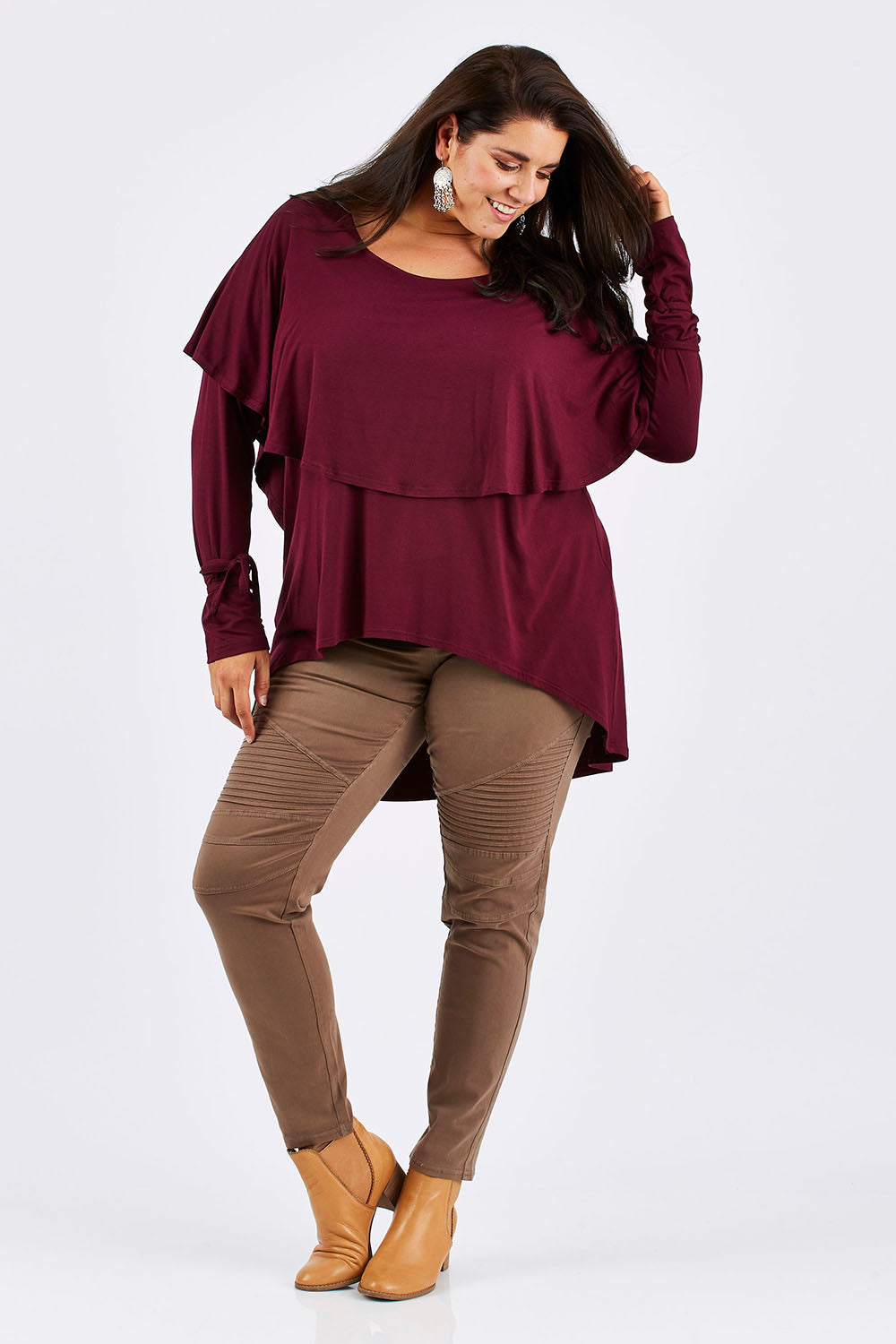 Model Mae wearing size 18 of the Cape Horn Tunic in colour Scarlet (Purple), from the front, showing the whole outfit
