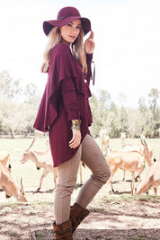 Model Marnee wearing size 10 of the Cape Horn Tunic in colour Scarlet (Purple), from the front, showing the whole outfit
