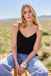 Model Tegan wearing size 10 of the Runaway Top in colour JetBlack (Black), from the front, showing the whole outfit
