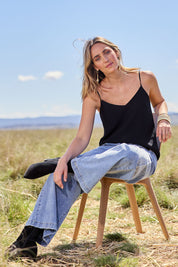 Model Tegan wearing size 10 of the Runaway Top in colour JetBlack (Black), from the front, showing the whole outfit