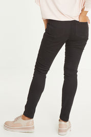 Model Cara wearing size 10 of the Wild Plains Stitched Jeggings in colour Black (Black), from the back