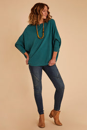 Model Emma wearing size 10 of the Wild Plains Stitched Jeggings in colour Denim (Blue), from the front, showing the whole outfit