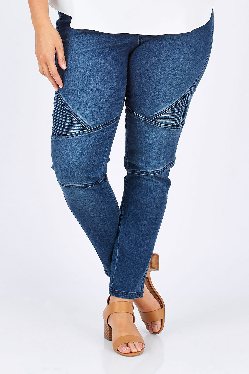 Model Mae wearing size 18 of the Wild Plains Stitched Jeggings in colour Denim (Blue), from the front, cropped image