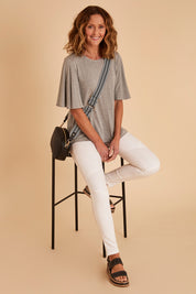 Model Emma wearing size 10 of the Wild Plains Stitched Jeggings in colour White (White), from the front, showing the whole outfit