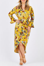 Model Jess wearing size 12 of the Spring Blossom Dress in colour Dijon, from the front, cropped image