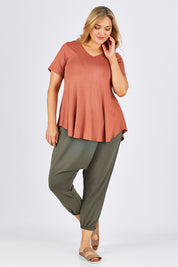 Model Ljubenka wearing size 18 of the Relax With Me Pants in colour Moss (Green), from the front, showing the whole outfit