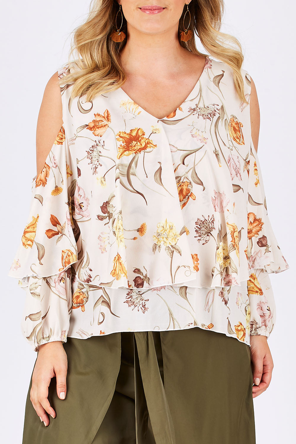 Model Jess wearing size 14 of the Flouncing Around Blouse in colour Fleur (Pink), from the front, cropped image