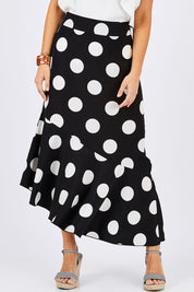 Model Georgia wearing size 10 of the Bellissimo Skirt in colour BlackDot (Black), from the front, cropped image
