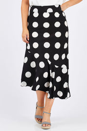Model Jess wearing size 12 of the Bellissimo Skirt in colour BlackDot (Black), from the front, cropped image