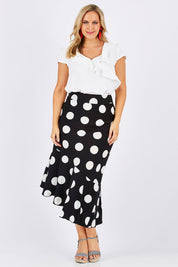 Model Jess wearing size 12 of the Bellissimo Skirt in colour BlackDot (Black), from the front, showing the whole outfit