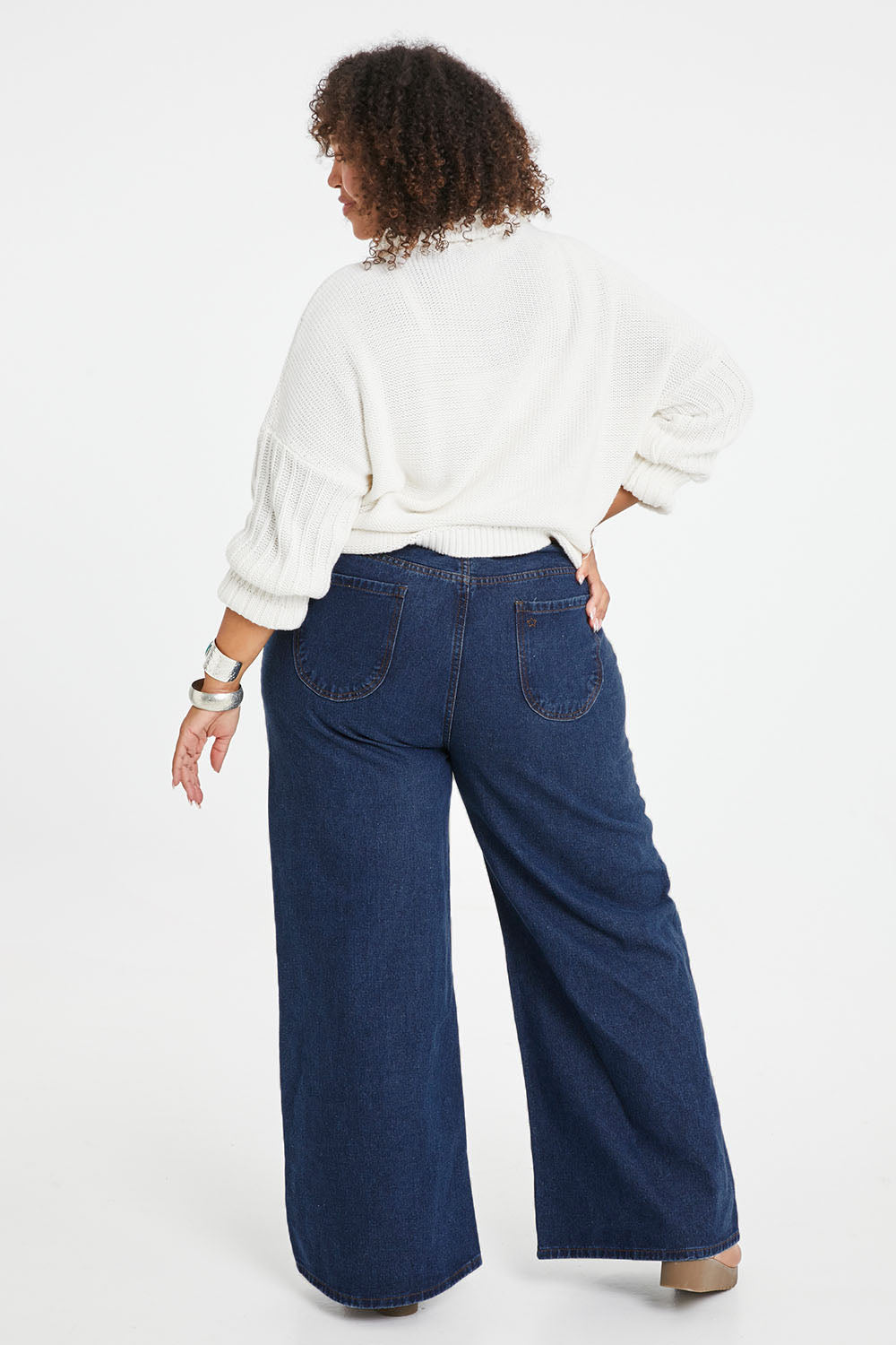 Model Alexis wearing size 16 of the Happy Me Wide Leg Jeans in colour Darkdenim (Blue), from the back