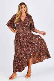 Model Fiona wearing size 16 of the Maximum Impact Dress in colour Rust, from the front, showing the whole outfit