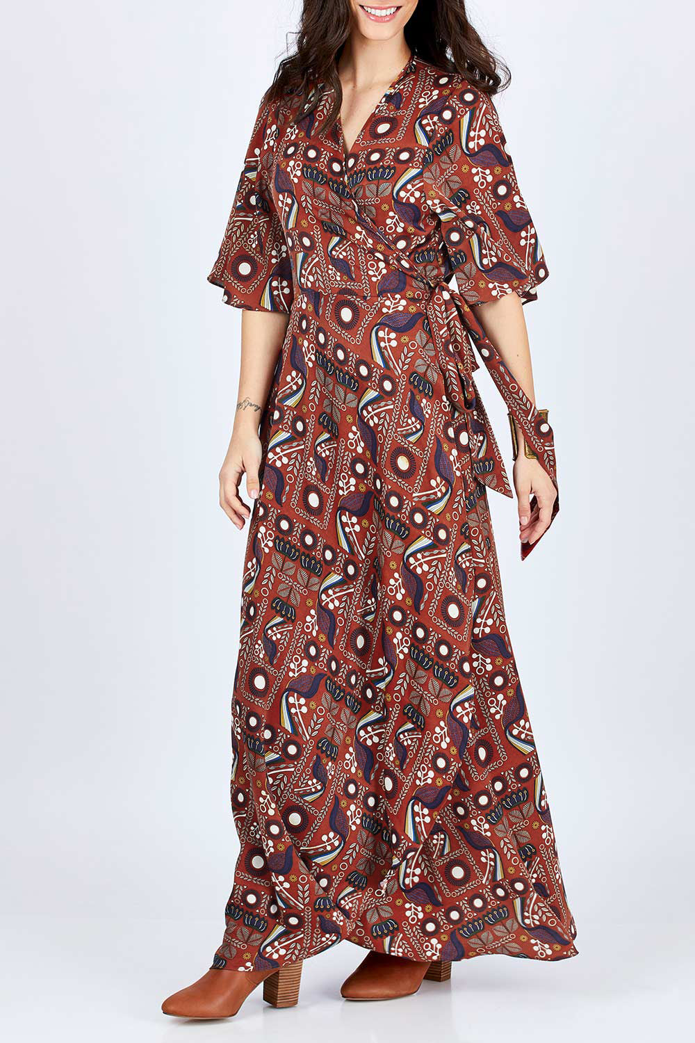 Model Georgia wearing size 10 of the Maximum Impact Dress in colour Rust, from the front, cropped image