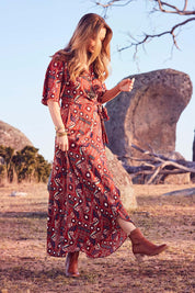 Model Marnee wearing size 10 of the Maximum Impact Dress in colour Rust, from the front, showing the whole outfit