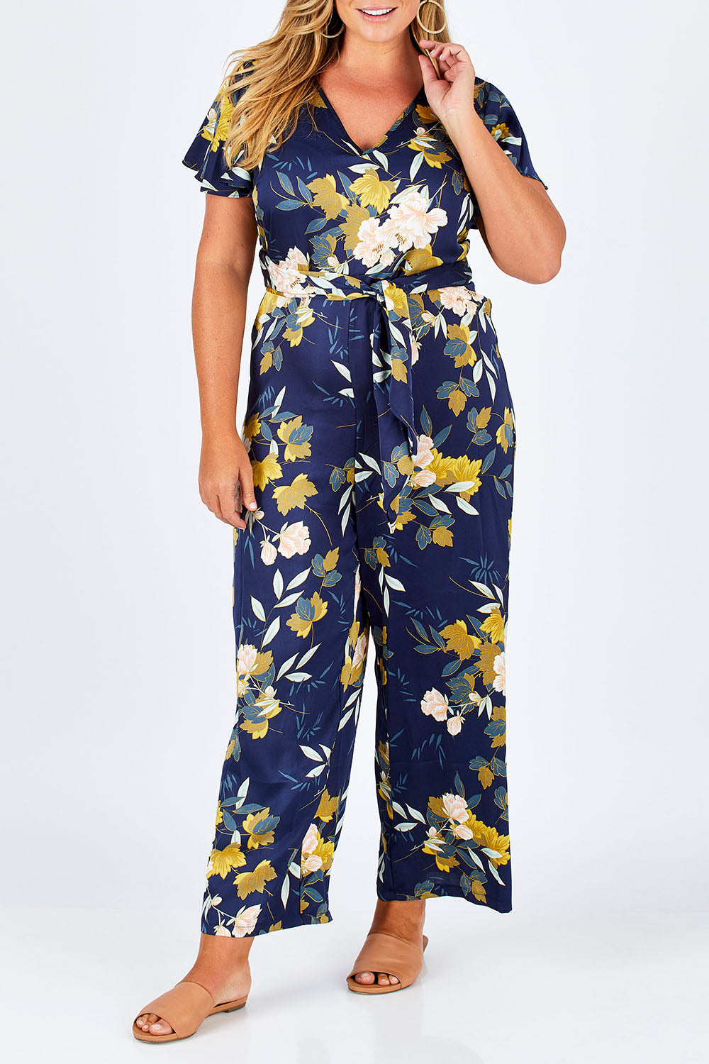 Model Fiona wearing size 16 of the Sunday Picnic Jumpsuit in colour NavyFluer (Blue), from the front, cropped image