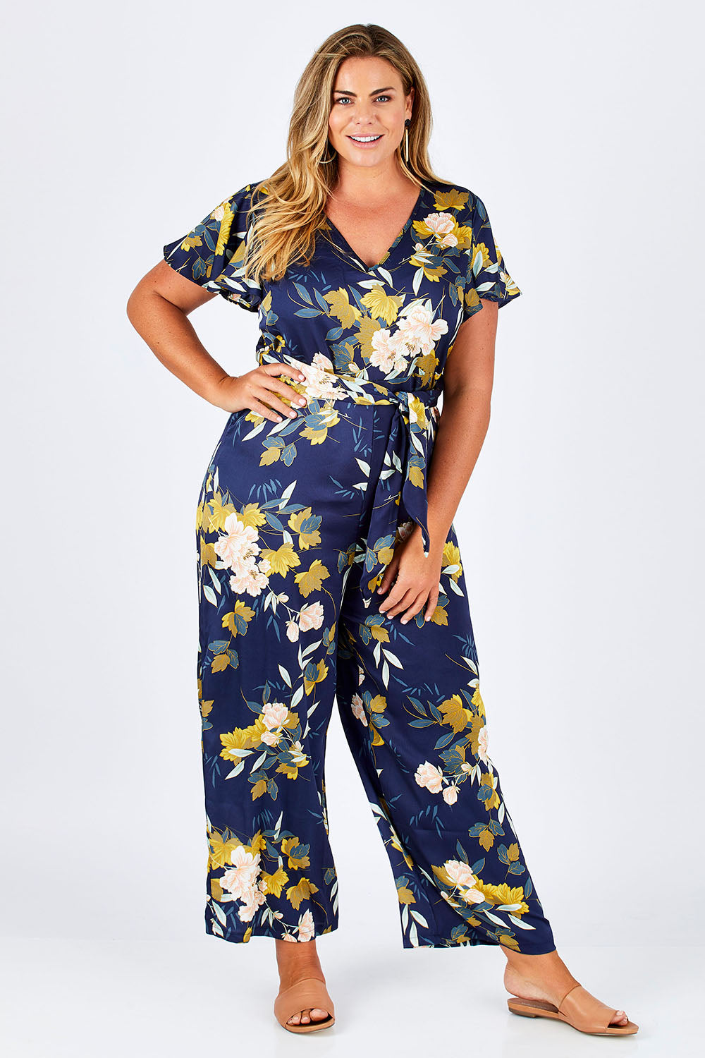 Model Fiona wearing size 16 of the Sunday Picnic Jumpsuit in colour NavyFluer (Blue), from the front, showing the whole outfit