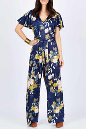 Model Georgia wearing size 10 of the Sunday Picnic Jumpsuit in colour NavyFluer (Blue), from the front, cropped image