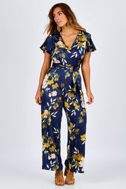 Model Laura wearing size 12 of the Sunday Picnic Jumpsuit in colour NavyFluer (Blue), from the front, showing the whole outfit