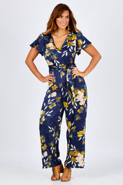 Model Laura wearing size 12 of the Sunday Picnic Jumpsuit in colour NavyFluer (Blue), from the front, showing the whole outfit