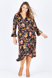 Model Natalia wearing size 14 of the Swanning Around Wrap Dress in colour BlackOrch (Black), from the front, showing the whole outfit