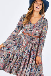 Model Palatina wearing size 14 of the Wind In My Hair Dress in colour Paisley (Red), from the front, cropped image