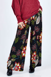 Model Georgia wearing size 10 of the Falling Leaves Wide Leg Pant in colour Black (Black), from the front, cropped image