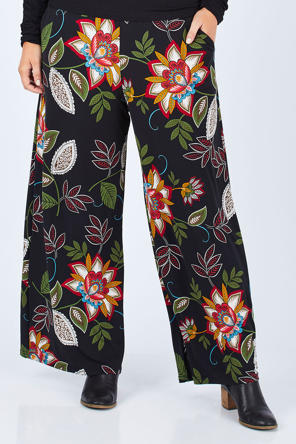 Model Jess wearing size 14 of the Falling Leaves Wide Leg Pant in colour Black (Black), from the front, cropped image