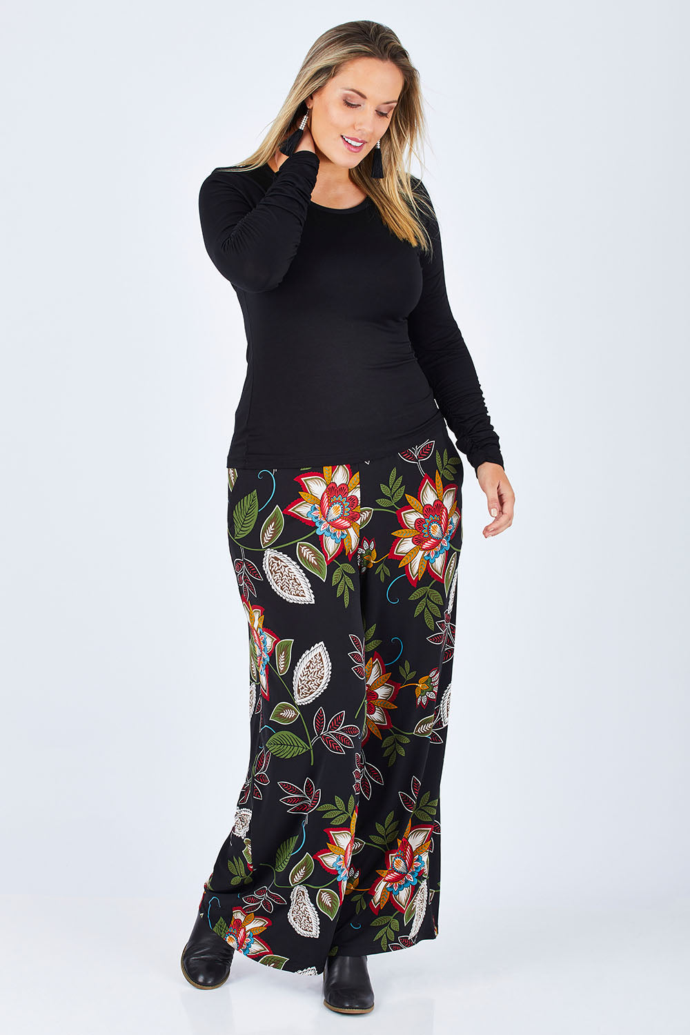 Model Jess wearing size 14 of the Falling Leaves Wide Leg Pant in colour Black (Black), from the front, showing the whole outfit