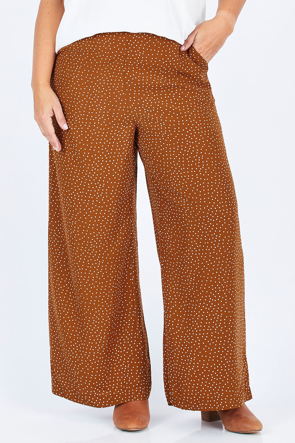 Model Stacey wearing size 14 of the Spotty About You Wide Leg Pants in colour Rust, from the front, cropped image