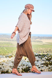 Model Marnee wearing size 10 of the On The Horizon Swing Top in colour Khaki (Green), from the front, showing the whole outfit