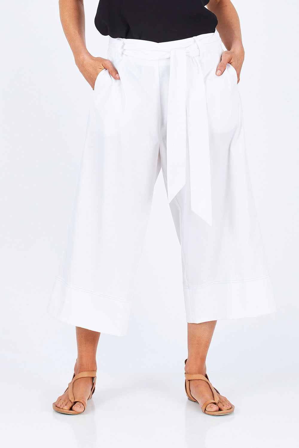Model Gemma wearing size 10 of the Chasing Seagull Pants in colour White (White), from the front, cropped image