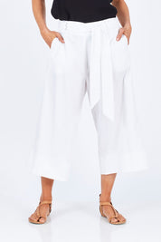 Model Gemma wearing size 10 of the Chasing Seagull Pants in colour White (White), from the front, cropped image