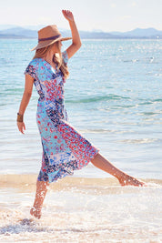 Model Marnee wearing size 10 of the Life Is Beautiful Wrap Dress in colour Fleurpatch (Blue), from the front, showing the whole outfit