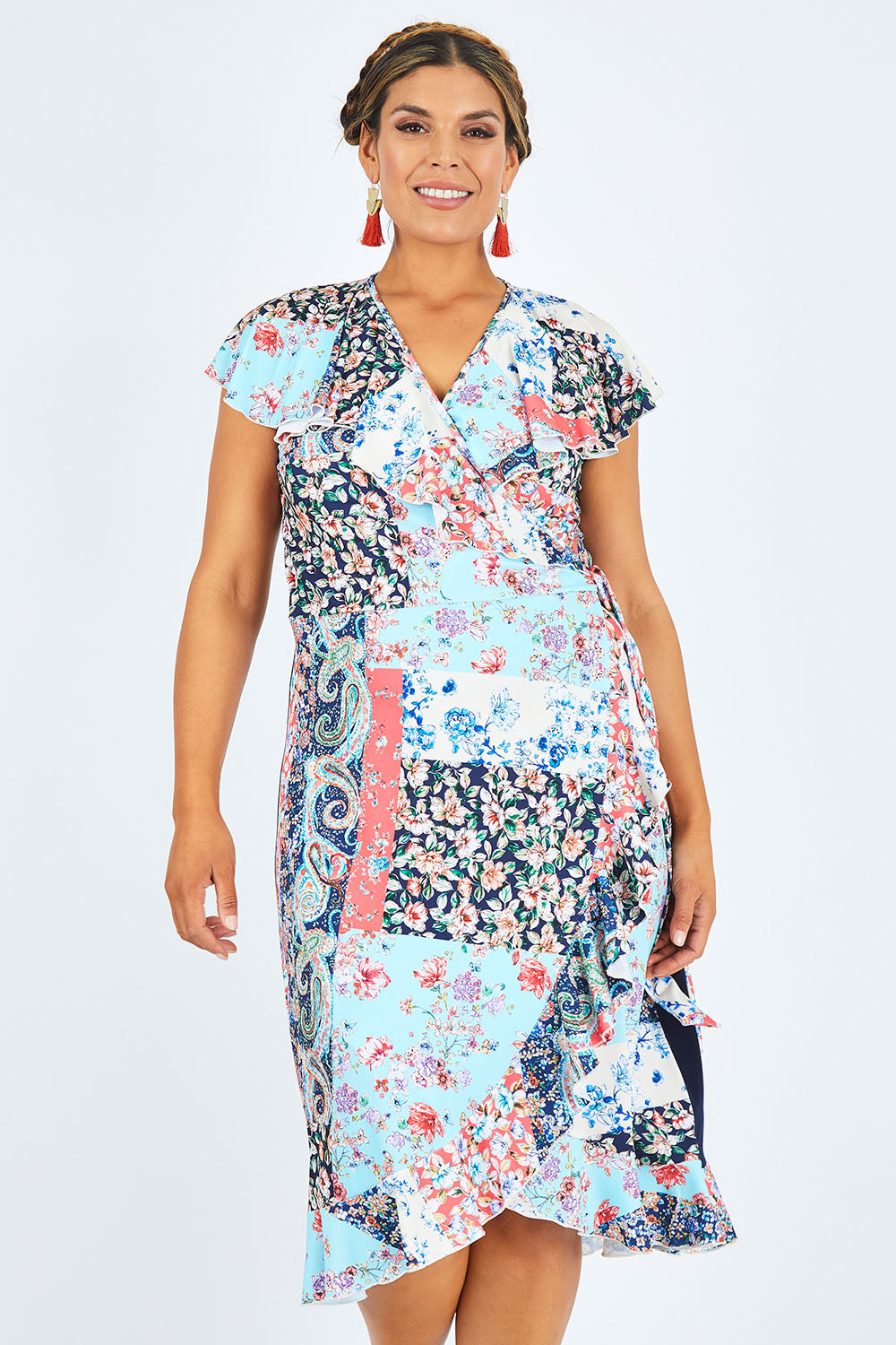 Model Palatina wearing size 14 of the Life Is Beautiful Wrap Dress in colour Fleurpatch (Blue), from the front, cropped image