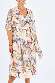 Model Palatina wearing size 14 of the Floating Through The Day Dress in colour Blush (Pink), from the front, cropped image