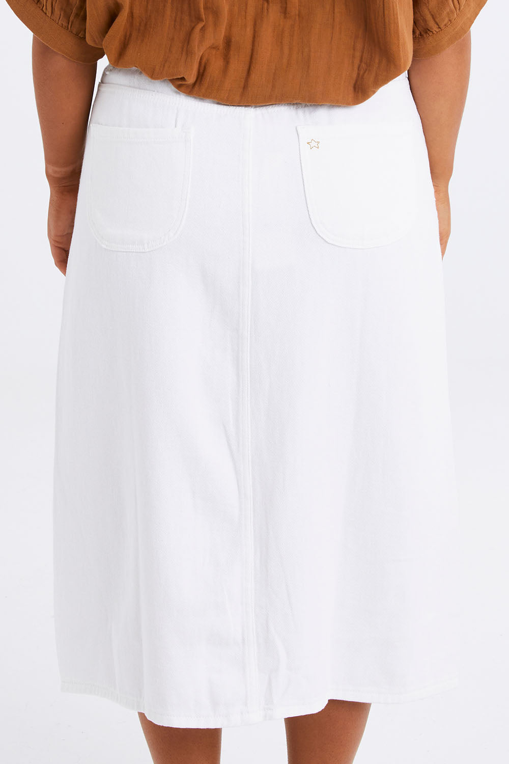 Model Monique wearing size 14 of the Happy Me Denim Skirt in colour White (White), from the back