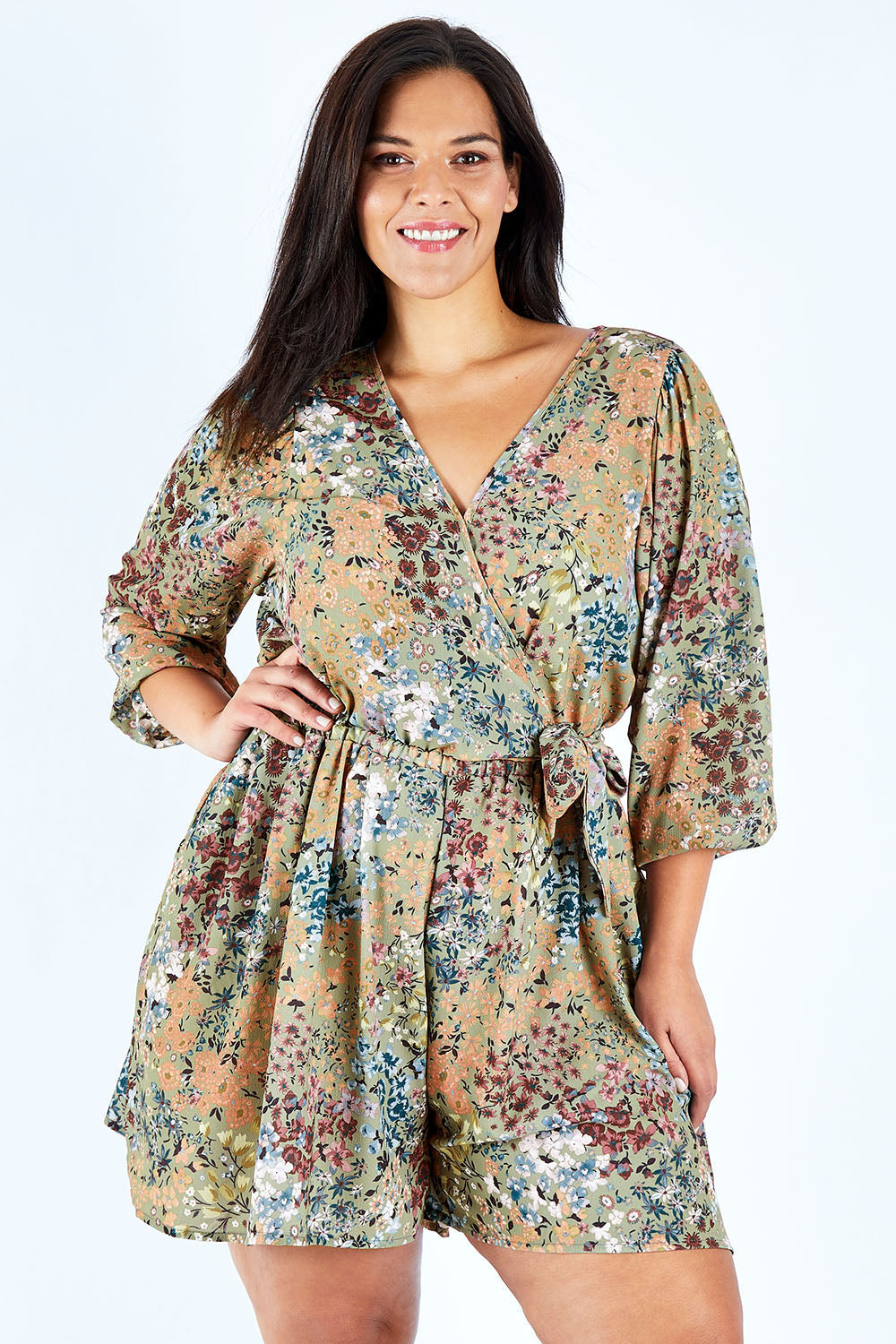 Model Lauren wearing size 18 of the Flower Safari Jumpsuit in colour Khaki (Green), from the front, cropped image