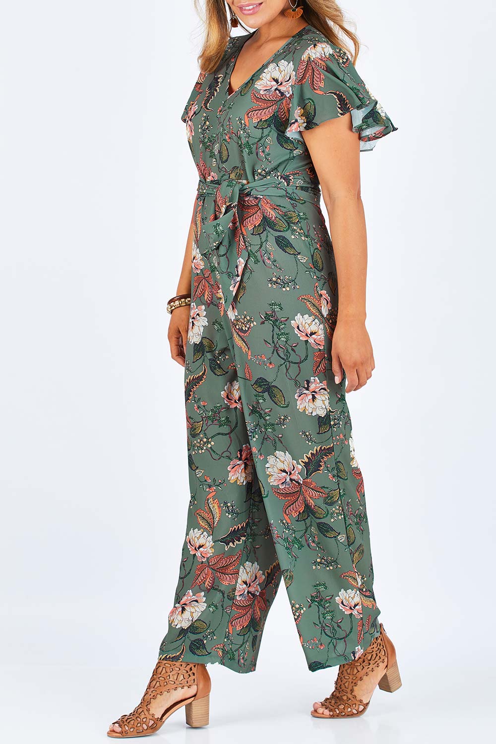 Model Palatina wearing size 14 of the Sunday Picnic Jumpsuit in colour Olivefleur (Green), from the front, cropped image
