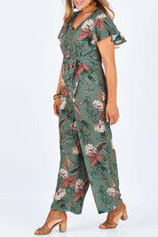 Model Palatina wearing size 14 of the Sunday Picnic Jumpsuit in colour Olivefleur (Green), from the front, cropped image