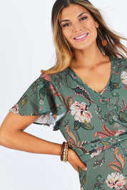 Model Palatina wearing size 14 of the Sunday Picnic Jumpsuit in colour Olivefleur (Green), from the front, cropped image
