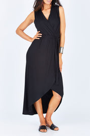 Model Gemma wearing size 10 of the Bamboo Freedom Faux Wrap Dress in colour Black (Black), from the front, cropped image