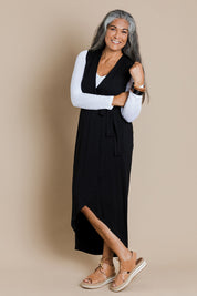 Model Nadine wearing size 10 of the Bamboo Freedom Faux Wrap Dress in colour Black (Black), from the front, showing the whole outfit