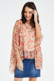 Model Andrea wearing size 10 of the Easy Peasy Throw Top in colour Orangepop, from the front, cropped image