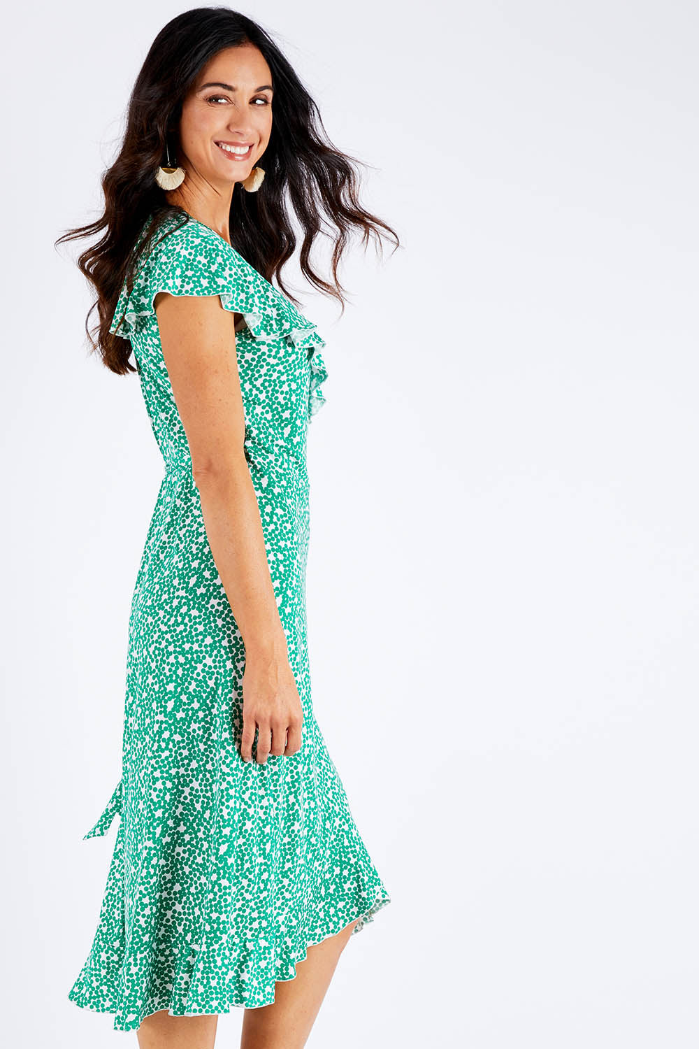 Model Gemma wearing size 10 of the Life Is Beautiful Wrap Dress in colour Greenspot (Green), from the front, cropped image