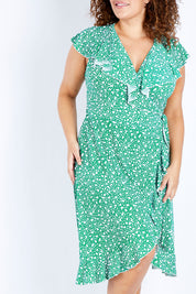 Model Jess wearing size 16 of the Life Is Beautiful Wrap Dress in colour Greenspot (Green), from the front, cropped image