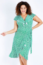Model Jess wearing size 16 of the Life Is Beautiful Wrap Dress in colour Greenspot (Green), from the front, cropped image