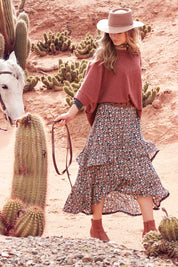 Model Marnee wearing size 10 of the Tiers Of Delight Skirt in colour Ditsy (Green), from the front, showing the whole outfit