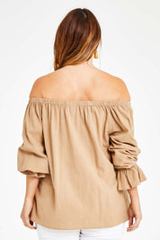 Model Laura wearing size 14 of the Twinkle In My Eye Off The Shoulder Top in colour Sand, from the back