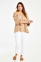 Model Laura wearing size 14 of the Twinkle In My Eye Off The Shoulder Top in colour Sand, from the front, showing the whole outfit